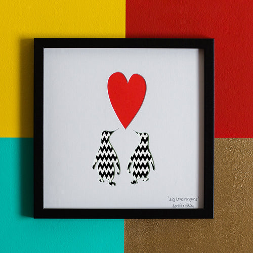 Two penguins with heart artwork 