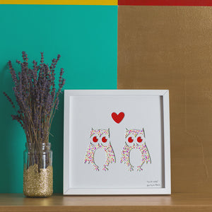 Two owls with a heart above their heads